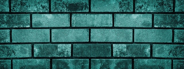 Dark teal rough brick wall closeup texture. Shabby turquoise color block masonry. Retro grunge brickwork background