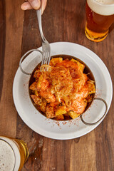 Patatas bravas, Spanish dish with fried potato and a spicy ali oli sauce.