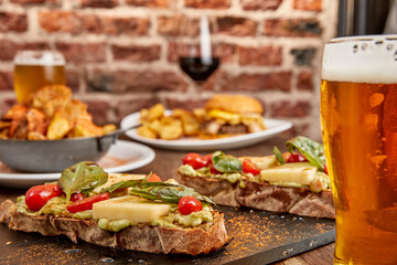 Table ready to enjoy with friends. Burguer, Patatas Bravas, Brusquetas with wine and beer.