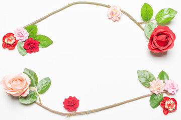 Frame made of rose flowers on white background. Top view with copy space.