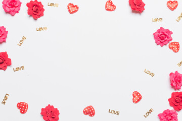 Frame made of rose flowers on white background. Top view with copy space.