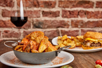 Table ready to enjoy with friends. Burguer, Patatas Bravas, Brusquetas with wine and beer.