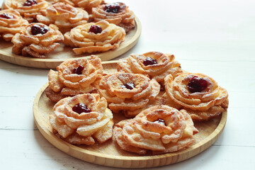 Carnival roses with jam and powdered sugar - traditional Polish cookies eaten during carnival and fat Thursday