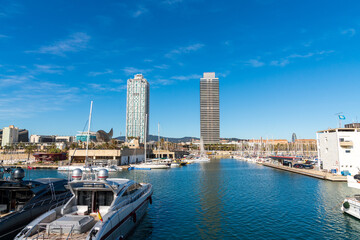Fototapeta na wymiar BARCELONA, SPAIN, FEBRUARY 3, 2021: Famous towers of the port of Barcelona, the Mapfre Tower and the Hotel Arts. Sunny winter day. During the covid-19 pandemic. Barcelona Skyline.