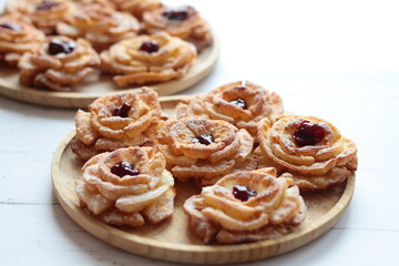 Carnival roses with jam and powdered sugar - traditional Polish cookies eaten during carnival and fat Thursday