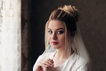 
portrait of a blonde bride with a veil