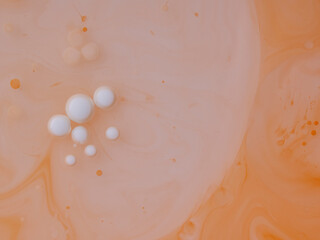 floating ink of different colors in milk with butter macro close up