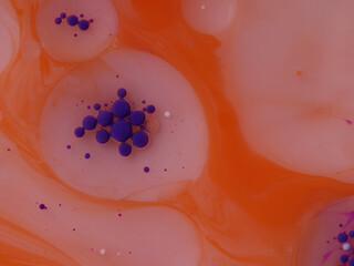 floating ink of different colors in milk with butter macro close up