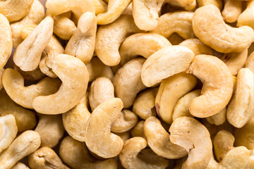 Background of big raw peeled cashew nuts, situated arbitrarily.