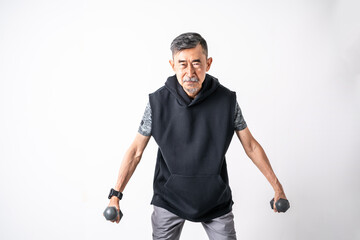 Happy and smiling Attractive of an older active senior Asian man training, exercising, workout at home with lifting weights dumbbells over on white background. Active and healthy senior concept