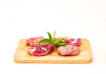 Fresh chicken gizzard on a wooden cutting board ready to cook