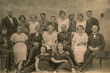 Latvia - CIRCA 1920s: Group photo of party guests. Vintage historical archive photo. Some men in uniform.