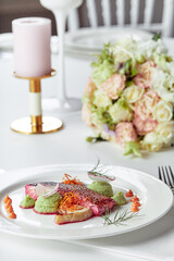 Tender dorado fillet with vegetables and basil. Banquet festive dishes. Gourmet restaurant menu. White background.