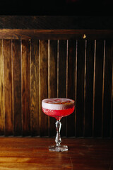 red alcoholic cocktail with foam in a glass