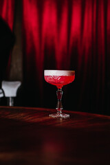 There is a red cocktail in the bar.
