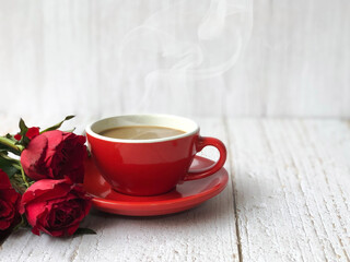 Coffee with cup and red roses on wooden floor and white background. Valentine concept.