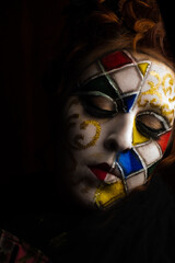 Carnival, a beautiful young woman with carnival makeup in the middle of a pandemic experiencing...