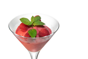 raspberries ice cream sorbet in martini glass with green mint leaves isolated on white, close up, copy space