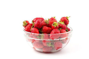 Fresh ripe delicious strawberries in a glass bowl on white background