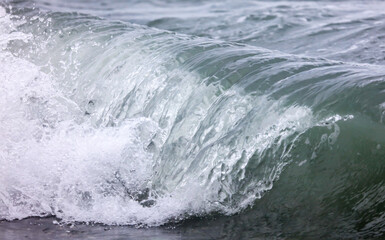 Naklejka na ściany i meble Wave in the sea with splashing water.