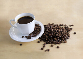 Coffee and Roasted coffee beans on Wooden floor. Leave space to write a message.