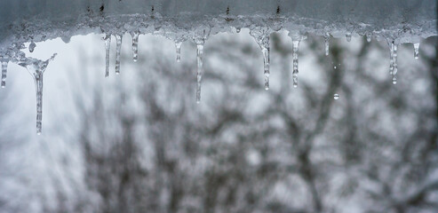 icicles hanging at the gutter under the roof