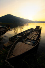 Rowing boat in a lake with sunset sky