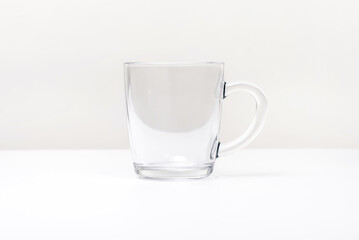 Empty glass cup with handle, isolated on white