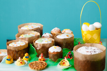 many Easter cake and eggs on table. Festive composition in Springtime. turquoise background