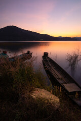 Rowing boat in a lake with sunset sky