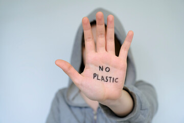 Say NO to plastic products. Concept. The man says no to the plastic bottle. No waste. Environment. On the palm it says to decline the offer of plastic products