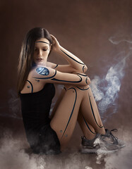 Girl cyborg robot sits on a brown background. white smoke around