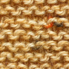 Brown yellow beige color knitted fabric seamless pattern for borderless fill. Knitted fabric repeating pattern for background close up.