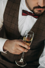 Portrait of a handsome man in a business suit holding a glass .