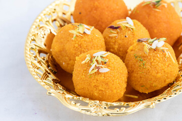 Indian Mithai Motichur Laddu Also Called Motichoor Ladoo Made Of Bengal Gram Flour Besan In Golden Tray. Meetha Laddoo Is Served On Festivals Like Holi Pooja Diwali Puja Eid Rakshabandhan And Weddings