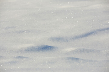 white snowdrift with blue shadows, winter texture