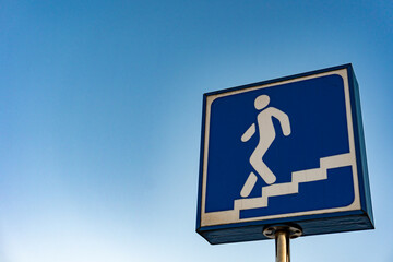 A blue sign of entrance to the underpass. symbol for subway metro station. European traffic...