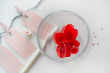 The glass with red heart shaped ice water with blank card for  writing of valentines