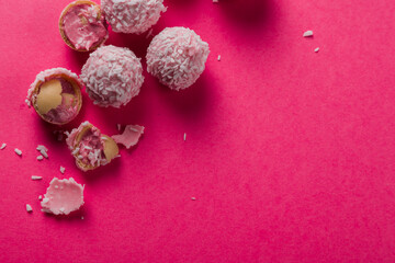 Fototapeta na wymiar Lots of delicious coconut candies on a bright pink background. Photo for postcard, wallpaper, banner. High quality photo