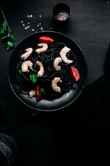 Black pasta with tiger prawns