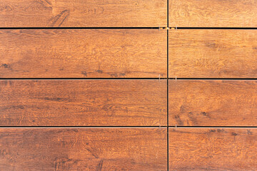 Building cladding with a ventilated facade, wooden texture, brown wood pattern