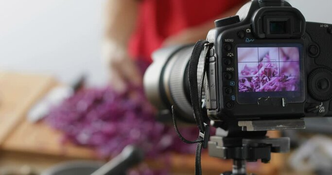 Food vlogging, red cabbage chopped into thin slices using sharp knife, sauerkraut making process recorded using dslr camera, focus on lcd screen, close-up