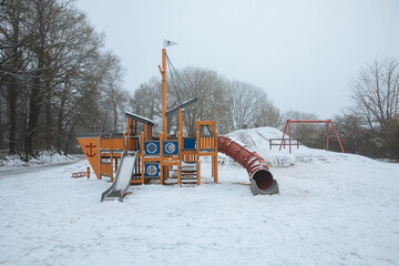 winter in the park. Outdoor playground covered in snow. No children in the playground. Great playground in winter. 