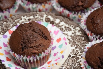 Chocolate cup cakes, colorfull hearts on liners, brown plate, Valentine's  day celebration