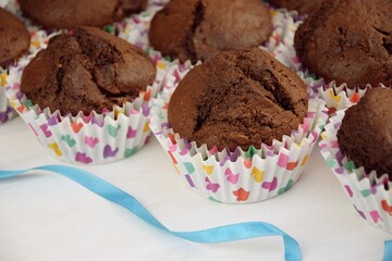 Chocolate cupcakes with alamonds, colorfull hearts onliners, blue ribbon, valentine cake