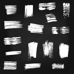 Set of vector white paint brush spots on chalkboard background. Big set of watercolor strokes isolated on black. Grunge texture, artistic design elements or text box