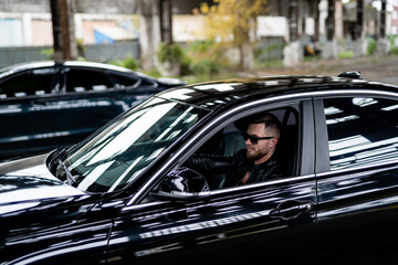 Attractive young man near car. Attractive elegant serious man near good car. Macho man in luxury...