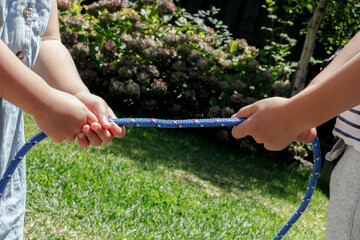 young children playing with rope