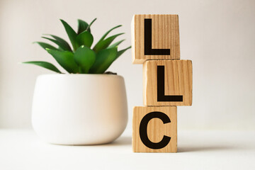 a word LLC on wooden cubes. business concept. business and Finance