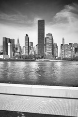 Black and white picture of Manhattan skyline seen from Roosevelt Island, New York City, USA.